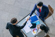 © Quality Stock Arts - Top view Group of business people meeting Hand shaking. Business team marketing deal projects. Present work. Agreement approved contract.