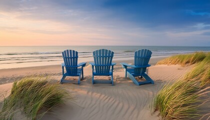 Sunset Serenity: Two Blue Adirondack Chairs on a Sandy Beach Facing the Ocean