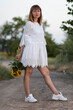 © Олег Мальшаков - Beautiful young girl in a white dress with flowers