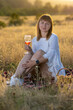© Олег Мальшаков - Beautiful young girl with a glass of wine on a picnic