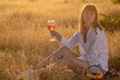 © Олег Мальшаков - Beautiful young girl with a glass of wine on a picnic