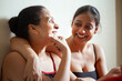 © Prashant ZI - Two Indian women are sitting, laughing, and talking lovingly to each other, capturing a moment of joy and connection.