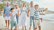 © Maass/peopleimages.com - Family, children and blowing bubbles at beach on walk, smile and bonding on vacation in summer. Parents, grandparents and kids on holiday with soap, games and happy with generations in sunshine