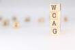 © PHalexaviles - WCAG acronym - Concept of Web Content Accessibility Guidelines written on wooden cubes isolated on white background with copy space for text phrase.