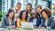 © Tekin - Multicultural successful smiling female businesswomen collaborating on a creative innovative project together at the corporate office while smiling at the laptop. Cheerful colleague having briefing.