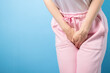 © yta - Urinary incontinence, woman holding crotch, female health, chronic disorder, urine leakage.