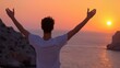 © ChimE - Inspiring silhouette of a man with hands raised at sunset symbolizing triumph, success, and adventure at Cap Formentor, Majorca.