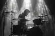 © Serhii - Musician drummer on stage with a drum kit instrument playing in the light of spotlights in the fog.