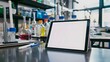 © PSCL RDL - A tablet with a blank white screen resting on a desk in a science lab, with lab equipment and safety goggles nearby, creating a dynamic education environmen