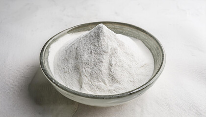 White zinc oxide powder in bowl on white table. Chemistry and medicine concept. Flat lay