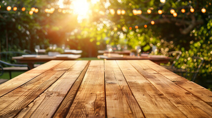 Empty wooden table at outdoor barbecue party.