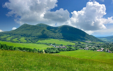 Summer trees and pasture in a beautiful mountain landscape. Busov – the highest peak of the Low Beskid Mountains with a height of 1002 m a.s.l., Slovakia.