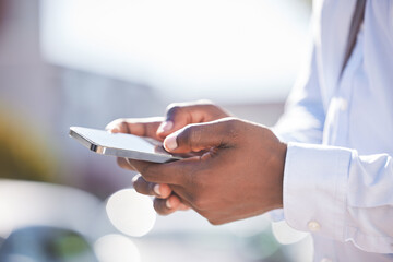 Canvas Print - Businessman, phone and hands in outdoor for typing, website scroll and online for conversation. Male person, employee and travel in city for commute, app and email business contact on social media