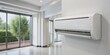 © kansak01 - Modern mini split heat pump air conditioning unit mounted on a white wall, with sleek design and digital display, indoors, against a blurred background.
