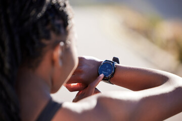 Wall Mural - Woman, smart watch and checking with time on mountain road for fitness, running or start workout in nature. Back of active female person or runner on wristwatch or screen for clock, race or tracking