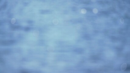 Wall Mural - abstract blurred water background with defocused sunlights, empty blue backdrop with glittering ligh
