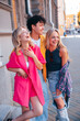 © halayalex - Group of young three stylish friends posing in the street. Fashion man and two cute female dressed in casual summer clothes. Smiling models having fun. Cheerful women and guy outdoors