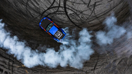 Wall Mural - Aerial top view car drifting diffusion race drift car with lots of smoke from burning tires on speed track, Professional driver drifting car with lots of white smoke.