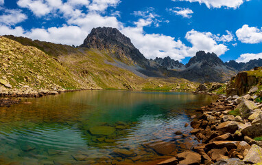 Lakes formed when the snow melted in a spring weather with white clouds in the blue sky. Lakes formed at the summit. Kackar Mountains. Verçenik