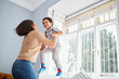 © Courtney/peopleimages.com - Mother, child and jump in bedroom for fun, playful and connection for bonding together in home. Happy people, mom and boy with lifting for game, entertainment and energy of single parent with kid