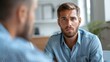 © PStyle - This image shows two people having a serious discussion in an office setting.
