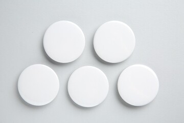 Poster - Blank white button badges on light background, flat lay. Mockup for design