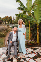 A disabled man in a wheelchair and his wife celebrate their wedding anniversary. The concept of including people with disabilities in all areas of life