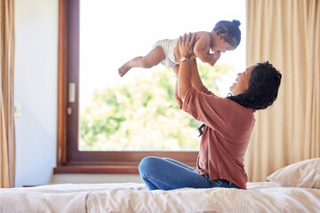 Canvas Print - Mother, baby and playing on bed in house for love, development and bonding together with trust. Mom, toddler and fun game in apartment bedroom for growth, wellness and care with support or lifting