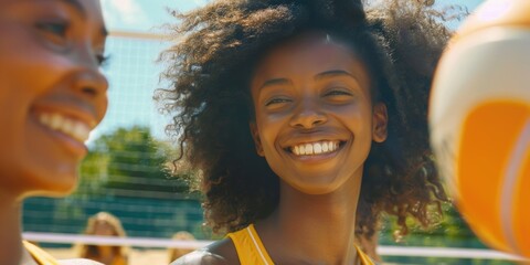 Two women having fun and laughing while playing volleyball