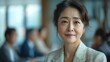 © zenith - A woman is smiling and wearing a white blazer