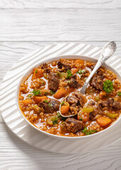 Wall Mural - beef barley soup in a bowl, top view