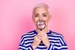 © deagreez - Photo of funky cheerful senior woman wear striped stylish clothes hand hold magnifying glass isolated on pink color background