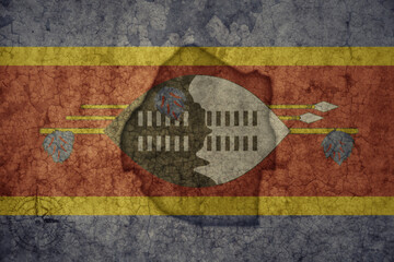 Wall Mural - map and flag of eswatini on a old vintage crack paper background .