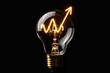 © Igor - Light bulb with grow up arrow rise in price of electricity Isolated on black background