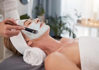 Canvas Print - Face mask, hand and woman at spa with skincare for organic treatment, cosmetics or dermatology on bed. Relax, mature client and masseuse with brush for beauty, wellness or luxury facial at resort