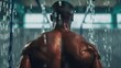 © Damerfie - A muscular man is seen from behind, showering with water droplets glistening on his back, highlighting the strength and definition of his muscles under the water flow.