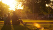 © VK Studio - Bathed in the golden light of sunset, a family enjoys a moment of togetherness on a baseball field, surrounded by lush grass and trees.