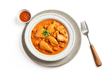 Wall Mural - Chicken Curry in a White Bowl with a Side of Sauce and Fork