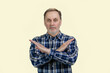 © DenisProduction.com - Portrait of a handsome serious man shows reject gesture with arms cross. Isolated on white background.
