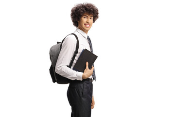 Wall Mural - Male college student holding books and smiling at camera