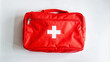 © Adisorn - A bright red bag with a white cross emblem, containing a first aid kit, lies on a clean white background, ready for emergency situations.