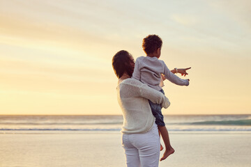 Poster - Mom, child and pointing at beach for love, care and vacation during summer with sunset, happiness and hug. Mother, boy and relax outdoor for nature, freedom and holiday with travel, bonding or fun