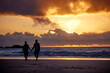 © peopleimages.com - Sunset, seaside and couple with love, holding hands and romance with tropical island, travel and honeymoon. Beach, golden hour and man with woman, relationship and holiday for anniversary or vacation