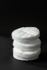 Poster - A pile of white wool sits on a dark background, creating a striking contrast