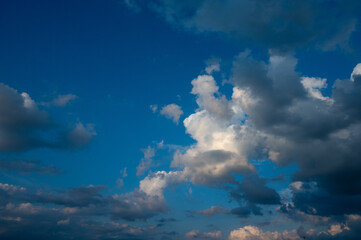 Evening sky in summer with cumulus clouds and wispy clouds