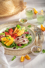 Wall Mural - Tasty and homemade salad with beef, cranberries, melon and tomatoes.