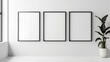 © qorqudlu - A trio of empty, black-edged frames aligned horizontally on a white wall contrasts with a sleek potted plant nearby.