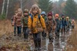 © fotofabrika - Children Hike Through Muddy Forest Path in Autumn