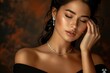 © Katavudh - A beautiful woman with her eyes closed, wearing a black dress and delicate jewelry.  Her skin glows in the warm light.  She is a portrait of elegance and grace.