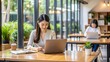 © Selene Studio - Asian woman studying in a coworking space, Asian, woman, studying, coworking, space, desk, laptop, books